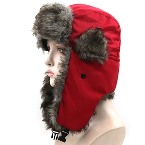 Red trapper hat with brown faux fur lining and ear flaps for winter outdoor skiing