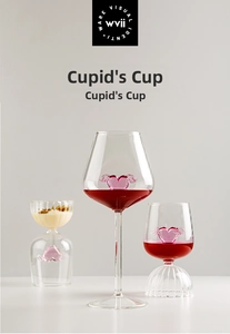 Close-up of Cupid's Cup glasses featuring pink winged heart interior detail