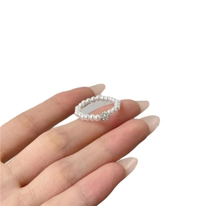 French vintage pearl and zircon elastic ring featuring a sparkling central diamond bead