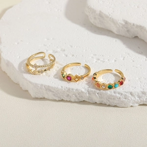 Three-piece set of adjustable gold rings with rhinestones and multi-colored gemstones