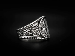 Macro shot of silver Jerusalem cross ring with vintage oxidized finish and engraved patterns