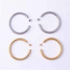 Detailed top view of gold and silver C-shaped stainless steel hoop earrings with glossy finish