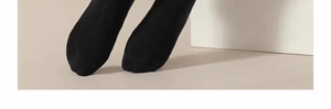 Detail of black sports sock showing ribbed vertical knit texture and elastic cotton blend