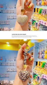 Detail of sparkling rhinestone heart keychains with gold hardware and patterned straps