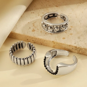 Detail of vintage silver-toned ring set with beaded, striped, and black crystal textures