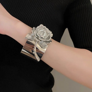 Macro shot of a 3D silver rose motif on an open cuff bracelet for women