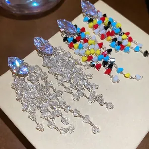 Sparkling crystal rhicombus tassel earrings with marquise stones on a display box