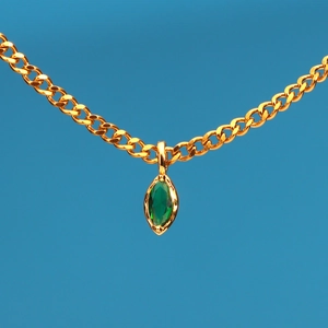 Elegant gold stainless steel necklace with marquise green stone on bright blue background
