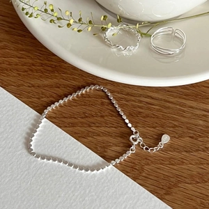 Detailed close-up of S925 sterling silver beaded bracelet with lobster clasp and tag
