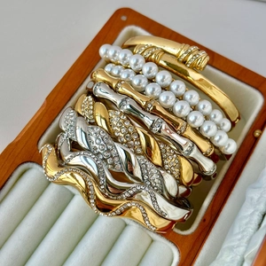 Detail shot of 18K gold plated stainless steel bracelets with pearls and crystals in a box