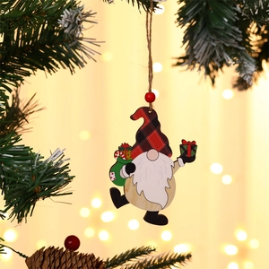 Detail of wooden Christmas gnome ornament with plaid hat on a pine tree branch