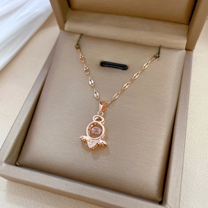 Rose gold titanium angel wing heart pendant necklace displayed in a luxury jewelry box