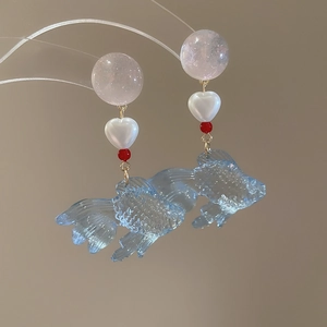 Detail of colorful resin goldfish earrings with heart pearls and pink beads
