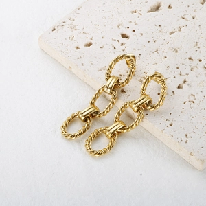 Elegant gold twisted chain drop earrings with three interlocking rings on stone base