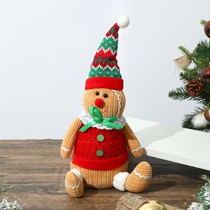 Detail of a plush gingerbread man doll featuring cozy knitted textures and festive colors