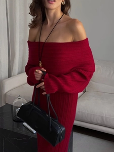 Close-up of red off-shoulder knit dress featuring vertical ribbed texture and slim fit