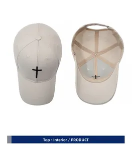 Detail view of beige baseball cap with black cross embroidery and adjustable metal buckle