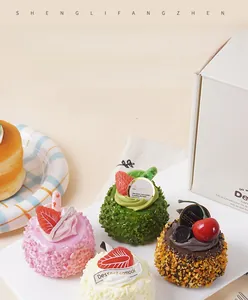 Close-up of assorted artificial coconut cakes with realistic cream and fruit toppings