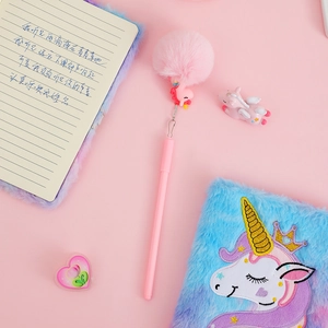 Close-up of pink unicorn gel pen featuring a fluffy pompom and dangling charm on top