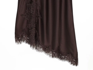 Detail shot of elegant dark brown satin fabric with intricate black lace trim and silk texture