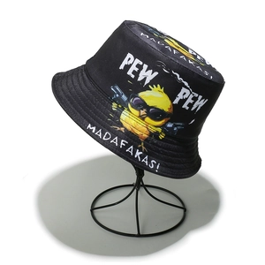 Detail of cartoon chick print and humorous text on a black bucket hat surface