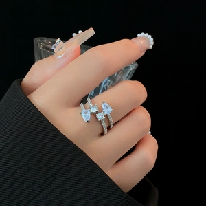 Detail of silver layered ring with light blue teardrop zircon and pavé crystals on hand