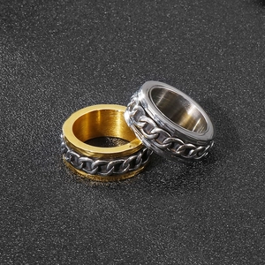 Close-up of industrial punk style rotatable chain rings in gold and silver finishes
