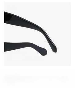 Dettaglio degli occhiali da sole neri lucidi con stanghette curve dal design ergonomico