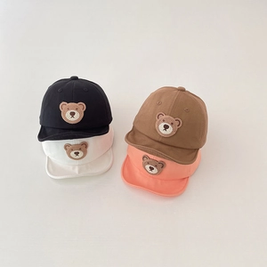 Detail view of cotton baby baseball caps in four colors with bear embroidery