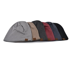 Detail of various knit beanies showing fine texture and brown leather F&S label