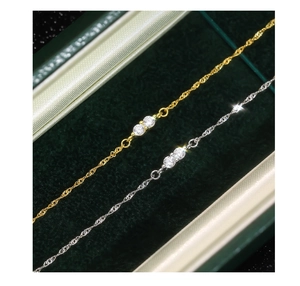 Close-up of gold and silver S925 sterling silver bracelets with sparkling zircon on velvet