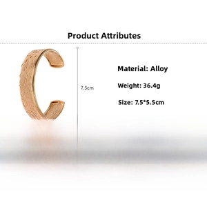 Detail view of golden open cuff bracelet with embossed patterns and 7.5cm height