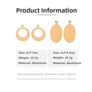 Detailed view of large gold-tone oval and round geometric aluminum drop earrings with specs