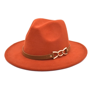 Detail of wide brim fedora hat featuring orange felt texture and gold chain buckle