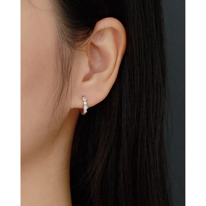 Close-up of 925 sterling silver hoop earrings with sparkling cubic zirconia on model
