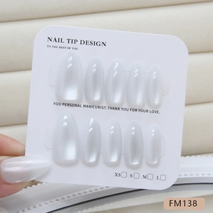 Handmade white cat-eye press-on nails set with elegant pearlescent finish on size card