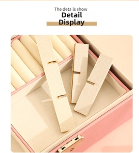 Macro view of a pink leather jewelry box with removable dividers and soft velvet lining