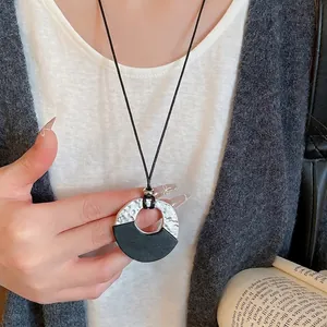 Retro wax rope necklace with geometric silver hammered metal and black wooden pendant