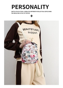 Detail showing colorful floral pattern on a white canvas backpack with adjustable straps