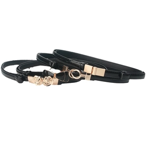 Three slim black adjustable belts with decorative gold floral and bow metal buckles