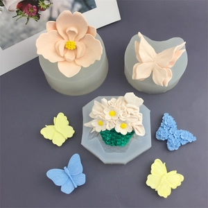 Silicone flower and butterfly molds for fondant and resin crafts on grey surface