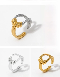 Detailed view of adjustable knot rings in gold and silver showing polished metallic texture
