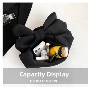 Black bow-knot tote bag showing large capacity with phone, perfume and umbrella inside