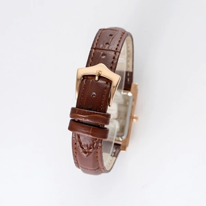 Vintage square watch with brown leather strap and gold buckle on a white background