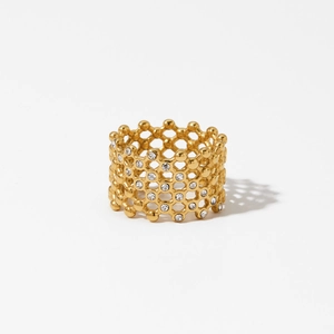 Gold honeycomb mesh openwork ring with sparkling crystals on white background