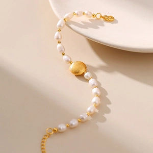 Elegant handmade freshwater pearl bracelet with gold beads and a brushed round charm