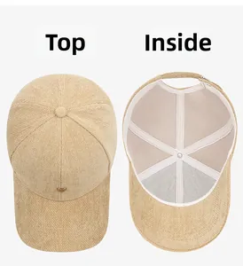 Detail view of beige baseball cap with metal heart buckle and interior lining construction