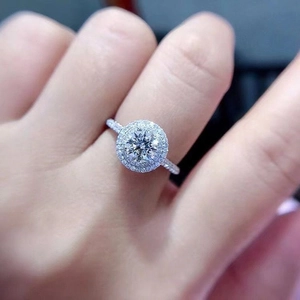Macro shot of double halo engagement ring with brilliant round center stone and pave band