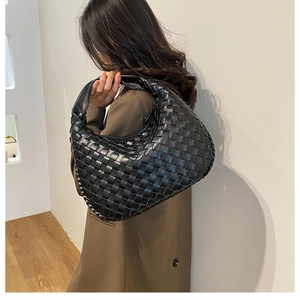 Detail of a black woven leather Hobo bag showing the geometric texture and large size