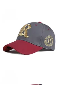 Detail of embroidered gold letter R on a two-tone baseball cap with contrast brim